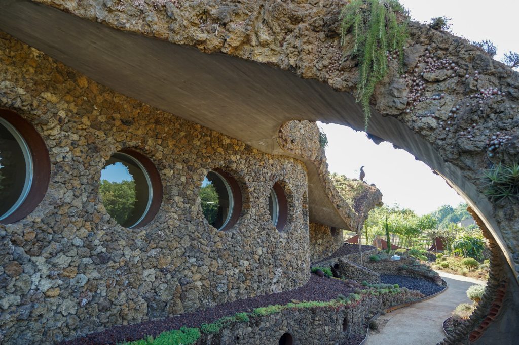 Curved south-facing façade of La Casa Verda with a series of circular windows.
